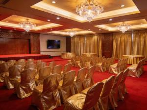 a conference room with chairs and a screen at Crown Comfortia Hotel Jashore in Jessore