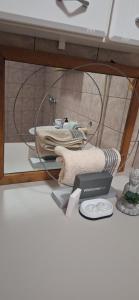 a table with a shelf with a scale and towels at Apartman's Villi in Jadranovo