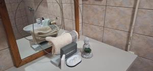 a small bathroom with a chair and a sink at Apartman's Villi in Jadranovo +21 photos