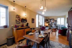 a living room with a table and a dining room at L'en vert appartement in Bagnères-de-Bigorre
