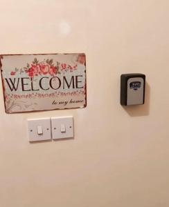 a sign on a wall with a welcome to my room at Sea View Penthouse in Larnaca