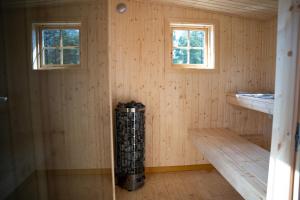 a room with two windows and a wood paneled wall at Mukka Mountain in Ruskola