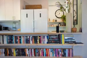 a shelf full of books and a clock on a wall at Mukka Mountain in Ruskola +41 photos