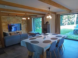 a living room with a table with chairs and a television at Chalet Martinky in Martin