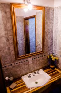 a bathroom with a sink and a mirror at Departamentos Malargue in Malargüe
