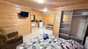 a room with wooden walls and a room with a table at Sadyba Dana in Tatariv