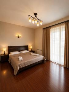 a bedroom with a bed with two towels on it at Dream House Hostel & Hotel in Yerevan