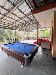 a pool table in the middle of a living room at Villa Pondok Aurora in Campaka