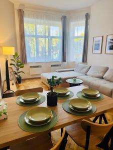 a living room with a table with plates on it at City Apartment 920 in Pardubice