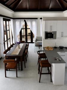 a kitchen with a large table and chairs in a room at Villa Mirada Maenam - Renovated Four Bedroom with Private Pool in Nathon Bay