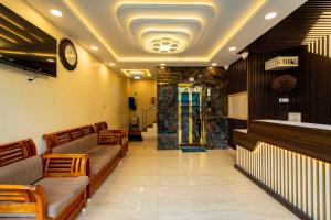 a waiting room with couches and a clock on the ceiling at Meeraa Residency in Rāmeswaram