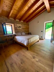 ein Schlafzimmer mit einem Bett in einem Zimmer mit Holzdecke in der Unterkunft Angel Chalet in Serina