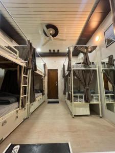 a room with two bunk beds and a hallway at Yovibe Stays, Dorms & Rooms, Assi Ghat, Varanasi in Varanasi