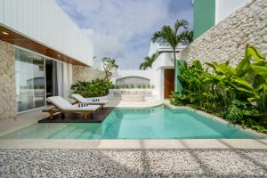 a pool in the backyard of a house at Lomo Boutique Hotel & Villas, Uluwatu in Uluwatu