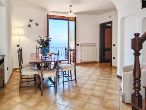 a dining room with a table and chairs and a window at Casa Rossa in Ravello +18 photos