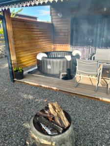 a patio with a couch and a fire pit at Les Camélias in Le Tampon