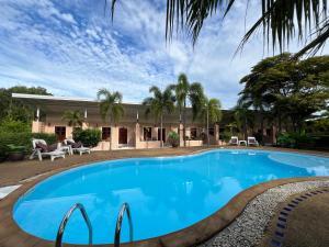 a swimming pool in front of a house at Krabi Discovery Resort in Tha Lane Bay