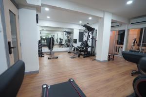 a gym with treadmills and machines in a room at The Spring Bangkok in Bangna