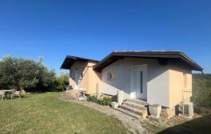 a small white house with a yard at Olive Garden Studio in Izola
