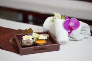 a box of towels and a tray of eggs and a flower at The Spring Bangkok in Bangna