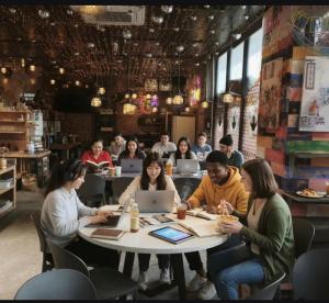 a group of people sitting at a table in a restaurant at Q FOX BLACK DIAMOND HOTEL in Kutchan
