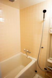 a bathroom with a bath tub and a shower at Nomachi Villa in Kanazawa +16 photos