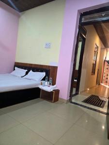 a hotel room with a bed and a glass door at Hotel Gopal Palace in Khātu +16 photos