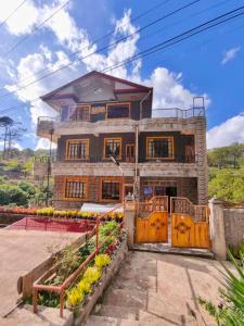 a house with a gate in front of it at Sagada Staycation with Mountain View - 1st Floor in Sagada +10 photos