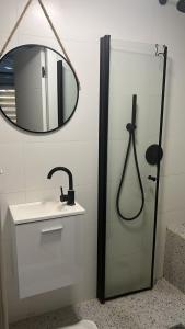a bathroom with a shower and a sink and a mirror at Emanuel Suite in Eilat +31 photos