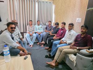 a group of men sitting in a room at Hotel Gopal Palace in Khātu