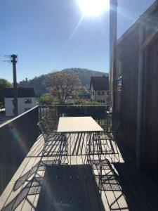 a table and chairs on top of a balcony at Exklusive Ferienlodge in Wertheim