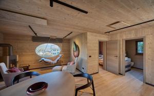 a room with a table and chairs and a bedroom at Exklusive Ferienlodge in Wertheim