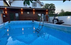a swimming pool in front of a house at La samba in Crisan