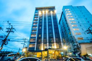 a tall building with lights on top of it at The Spring Bangkok in Bangna