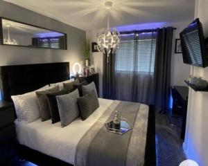 a bedroom with a large bed with a tray on it at The Grand Avora Apartment With 3 Ac And Free Parking in Lahore