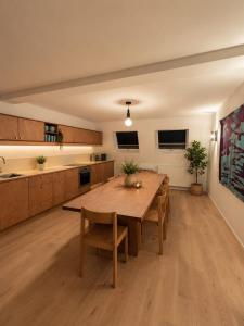 a large kitchen with a wooden table and chairs at Maison Bruxelles in Brussels