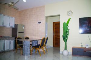 a kitchen with a table and chairs and a plant at Bandari House Malindi in Zanzibar City