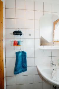 a bathroom with a sink and a blue towel at Gästehaus Berger in Tröpolach +40 photos