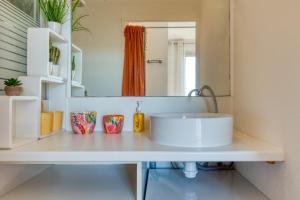 a bathroom with a sink and a mirror at Le Duplex des Halles-Balcon & Clim in Sète +19 photos