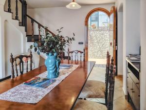 a dining room with a table with a vase on it at Casa Rossa in Ravello