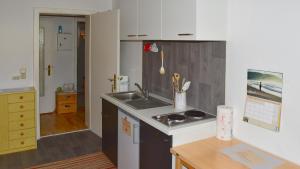a kitchen with a sink and a counter top at FeWo im Dreiländereck in Büchlberg