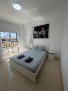 a bedroom with a bed with two black towels on it at Villa Mares Puig in Llucmajor +12 photos