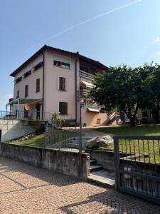 a building with a fence in front of it at Executive Lake View with Private Garden in Lugano