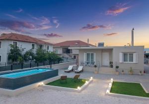 a villa with a swimming pool and a house at Alivio Country House in Nafplio