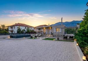 a house with a patio with mountains in the background at Alivio Country House in Nafplio