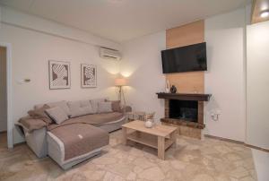 a living room with a couch and a fireplace at Alivio Country House in Nafplio