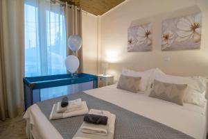 a bedroom with a large bed with two towels and balloons at Alivio Country House in Nafplio +112 photos