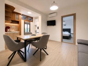 a dining room and living room with a table and chairs at Guestrooms Zoya in Chernomorets