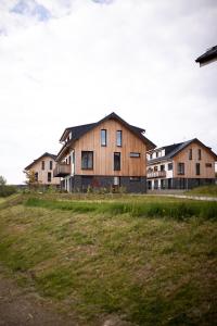 a group of houses on a grassy field at Malé Lipno 1075 in Černá v Pošumaví