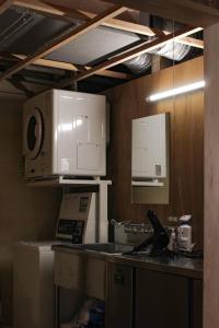 a kitchen with white appliances and a counter top at 一棟貸しホテル Shirahama WAKO in Shirahama